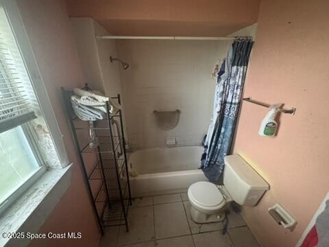 1236 Jackson St, Cocoa, FL 32922 - full bathroom featuring toilet, shower / bath combo with shower curtain, and tile patterned floors