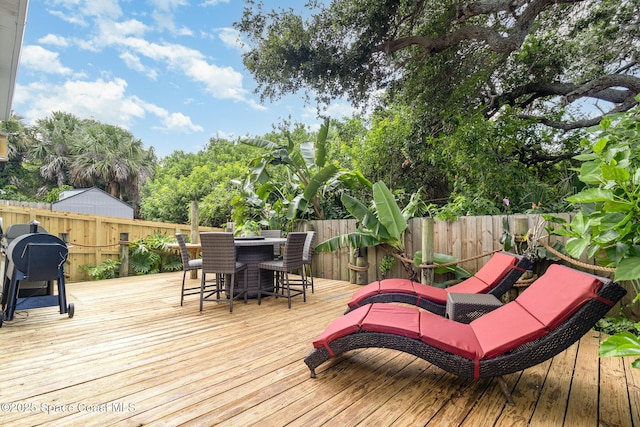 142 Ocean Garden Ln, Cape Canaveral, FL 32920 - wooden deck featuring a fenced backyard and a grill