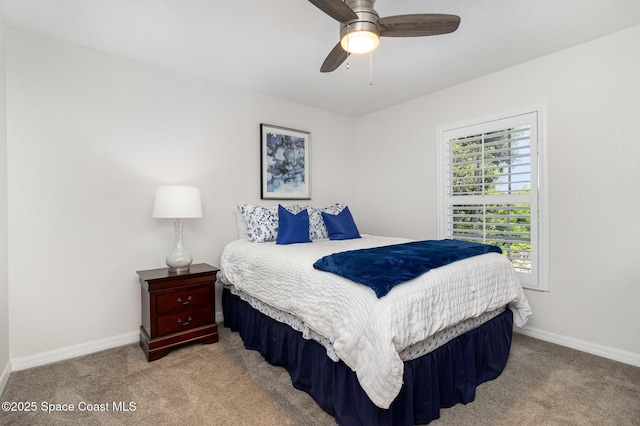 142 Ocean Garden Ln, Cape Canaveral, FL 32920 - carpeted bedroom featuring baseboards and a ceiling fan