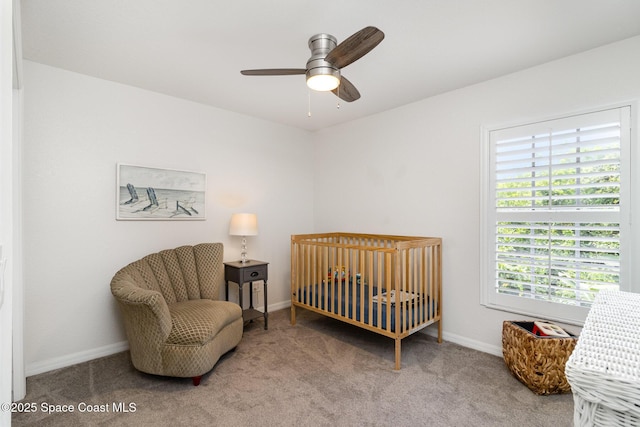 142 Ocean Garden Ln, Cape Canaveral, FL 32920 - bedroom featuring carpet, a crib, and a ceiling fan