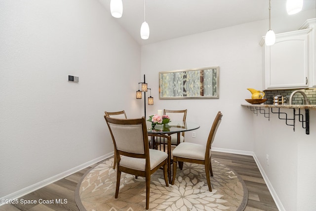142 Ocean Garden Ln, Cape Canaveral, FL 32920 - dining area with light wood-style flooring and vaulted ceiling