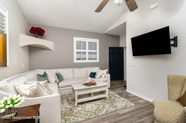 142 Ocean Garden Ln, Cape Canaveral, FL 32920 - living room featuring wood finished floors, a ceiling fan, and vaulted ceiling