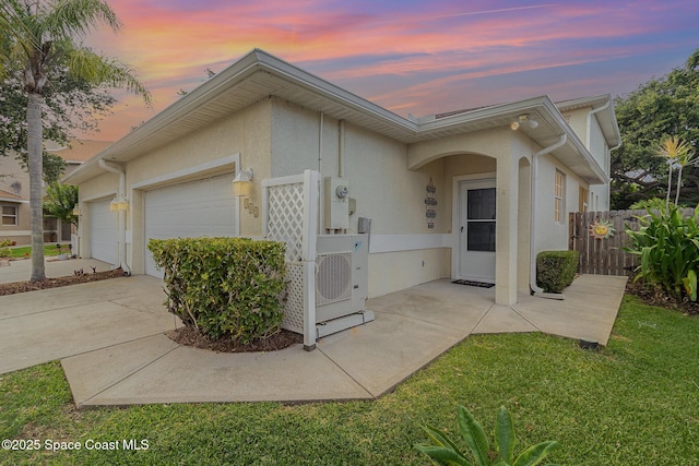 142 Ocean Garden Ln, Cape Canaveral, FL 32920 - view of front of home with a garage, stucco siding, and concrete driveway