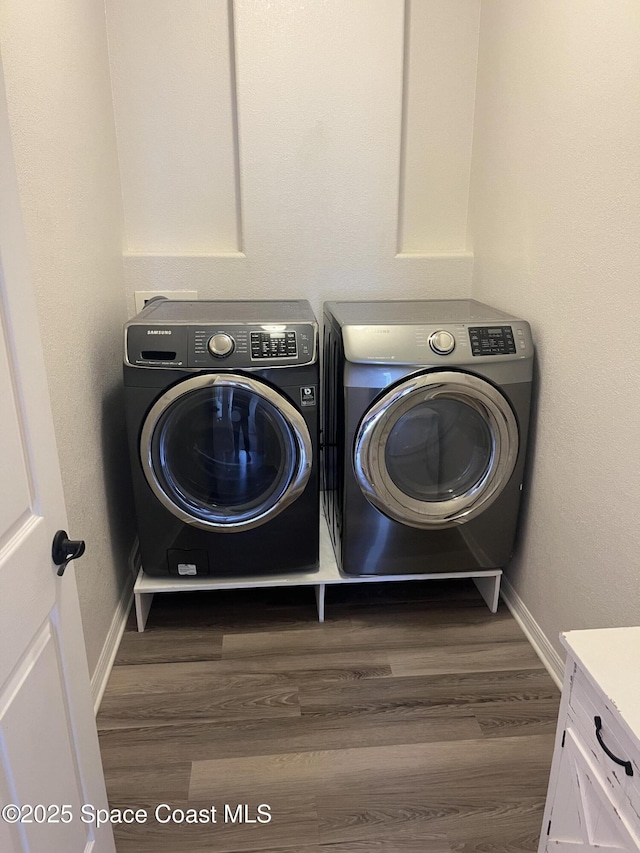 142 Ocean Garden Ln, Cape Canaveral, FL 32920 - washroom featuring washing machine and dryer and dark wood finished floors