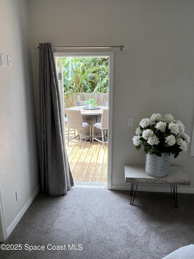 142 Ocean Garden Ln, Cape Canaveral, FL 32920 - doorway to outside with baseboards and carpet floors