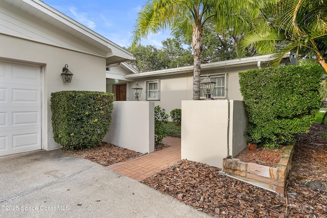 320 Cocoa Ave, Indialantic, FL 32903 - property entrance with stucco siding and a garage
