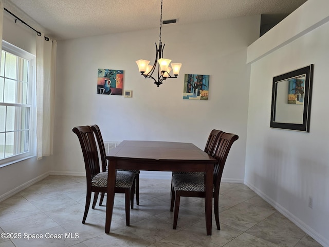1150 Ida Way, Melbourne, FL 32940 - dining room with a chandelier, a textured ceiling, and light tile patterned flooring