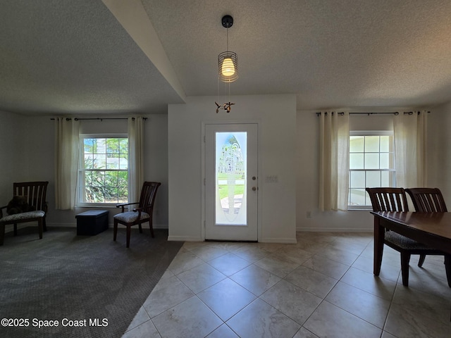 1150 Ida Way, Melbourne, FL 32940 - entryway with a textured ceiling and light tile patterned flooring