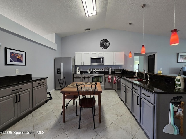 1150 Ida Way, Melbourne, FL 32940 - kitchen with stainless steel appliances, a peninsula, dark countertops, a textured ceiling, and high vaulted ceiling