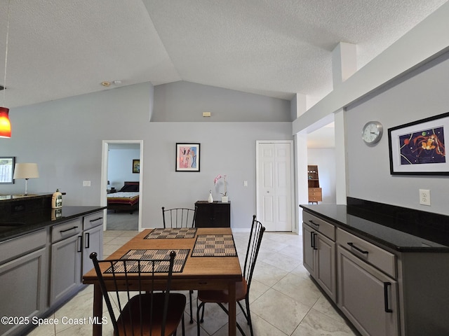 1150 Ida Way, Melbourne, FL 32940 - dining space with lofted ceiling, light tile patterned floors, and a textured ceiling