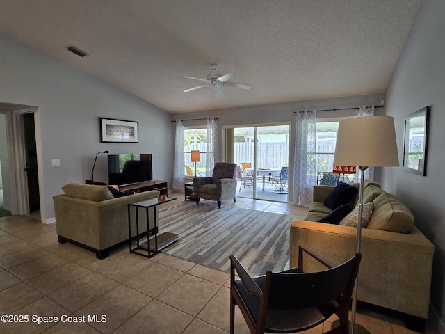 1150 Ida Way, Melbourne, FL 32940 - living area with vaulted ceiling, a textured ceiling, light tile patterned floors, a ceiling fan, and plenty of natural light