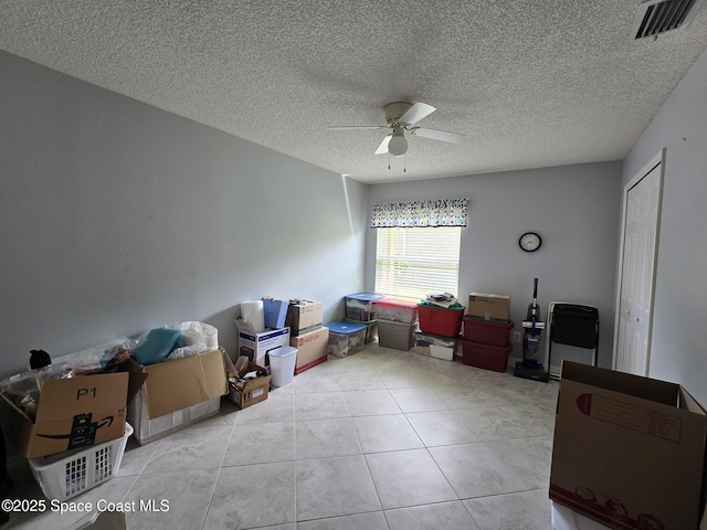 1150 Ida Way, Melbourne, FL 32940 - bedroom featuring light tile patterned flooring, a ceiling fan, and a textured ceiling