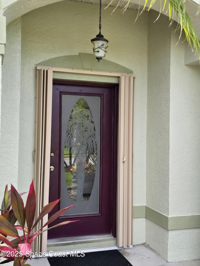 1150 Ida Way, Melbourne, FL 32940 - doorway to property featuring stucco siding