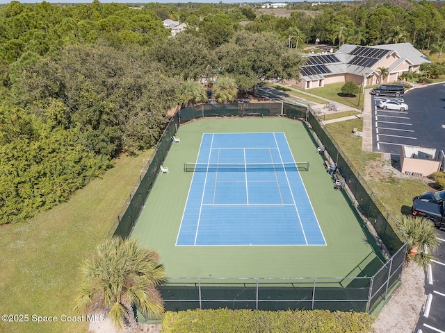 1150 Ida Way, Melbourne, FL 32940 - view of tennis court featuring a wooded view