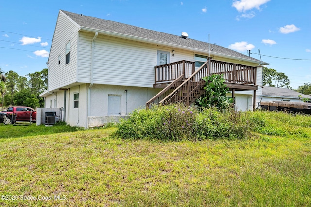 1620 Wichita Blvd SE, Palm Bay, FL 32909 - back of house featuring a wooden deck, stairs, a yard, and central air condition unit