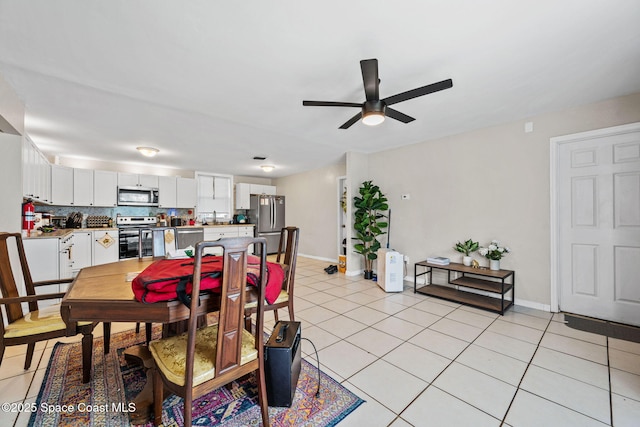 1620 Wichita Blvd SE, Palm Bay, FL 32909 - dining area with ceiling fan, light tile patterned floors, and baseboards