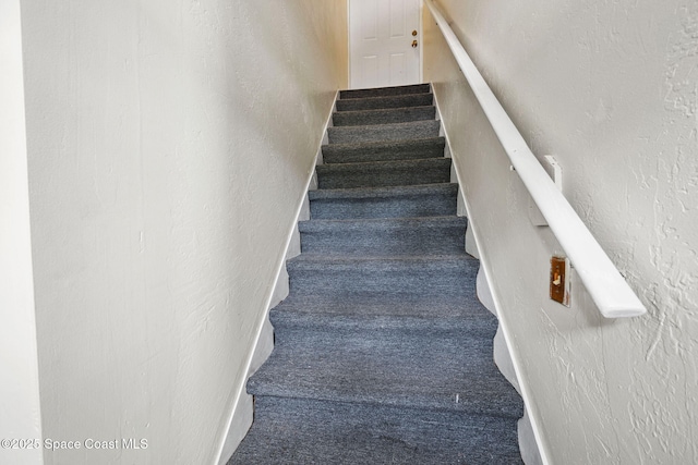 1620 Wichita Blvd SE, Palm Bay, FL 32909 - staircase with a textured wall and carpet flooring