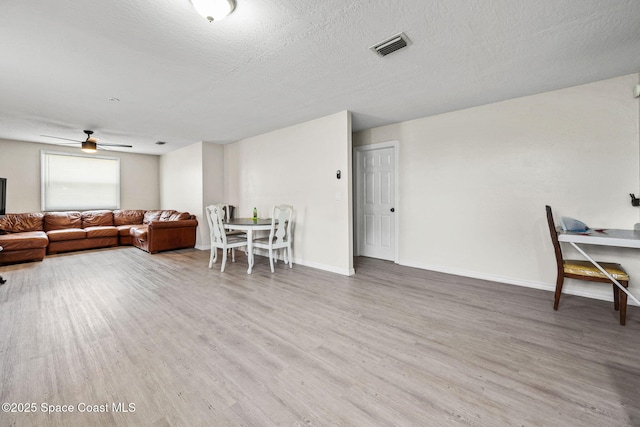 1620 Wichita Blvd SE, Palm Bay, FL 32909 - living area with wood finished floors, baseboards, ceiling fan, and a textured ceiling
