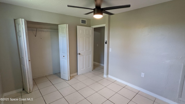 1620 Wichita Blvd SE, Palm Bay, FL 32909 - unfurnished bedroom featuring a closet, light tile patterned flooring, a ceiling fan, and baseboards