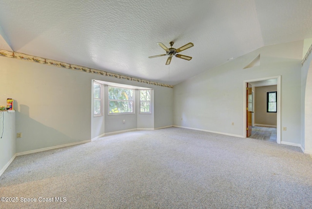 5320 Shadwell Ave, Cocoa, FL 32926 - carpeted spare room with lofted ceiling, a ceiling fan, and a textured ceiling