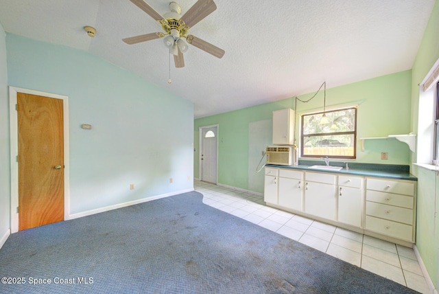 5320 Shadwell Ave, Cocoa, FL 32926 - unfurnished living room with light colored carpet, ceiling fan, lofted ceiling, a textured ceiling, and light tile patterned floors