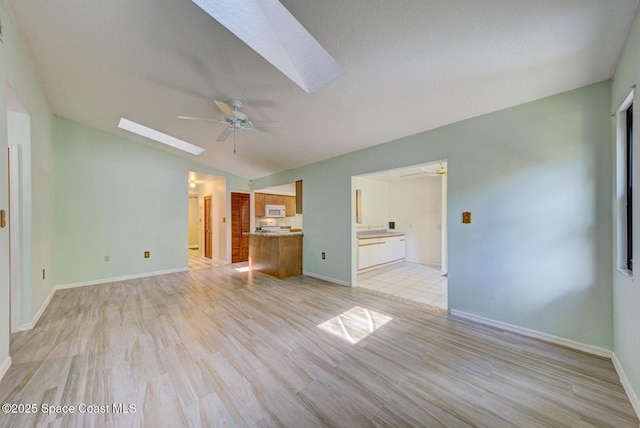 5320 Shadwell Ave, Cocoa, FL 32926 - unfurnished living room featuring a skylight, a ceiling fan, light wood-style floors, and lofted ceiling