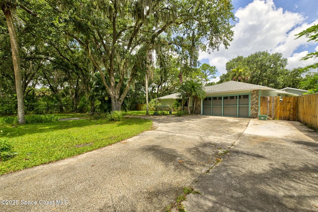 5320 Shadwell Ave, Cocoa, FL 32926 - view of front of house featuring an attached garage, stone siding, and concrete driveway