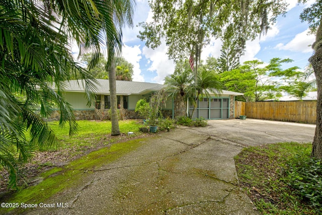 5320 Shadwell Ave, Cocoa, FL 32926 - view of front facade featuring stone siding, concrete driveway, and an attached garage