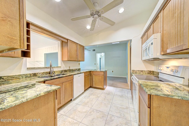 5320 Shadwell Ave, Cocoa, FL 32926 - kitchen featuring white appliances, vaulted ceiling, light stone counters, a peninsula, and recessed lighting
