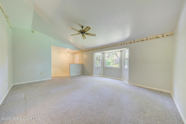 5320 Shadwell Ave, Cocoa, FL 32926 - empty room featuring vaulted ceiling, carpet flooring, ceiling fan, and a textured ceiling