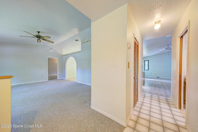 5320 Shadwell Ave, Cocoa, FL 32926 - spare room featuring ceiling fan, a textured ceiling, vaulted ceiling, and light carpet
