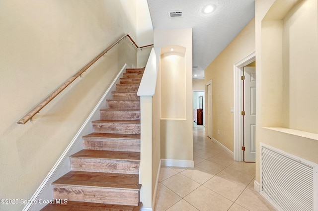 2178 Tanager Ct, Melbourne, FL 32903 - stairs featuring tile patterned floors and baseboards