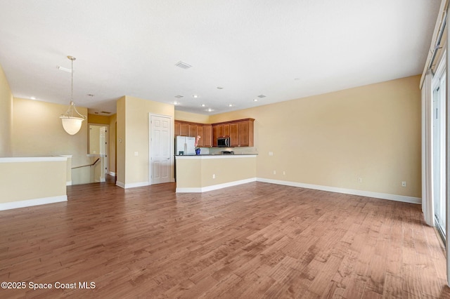 2178 Tanager Ct, Melbourne, FL 32903 - unfurnished living room featuring light wood-style floors, baseboards, and recessed lighting