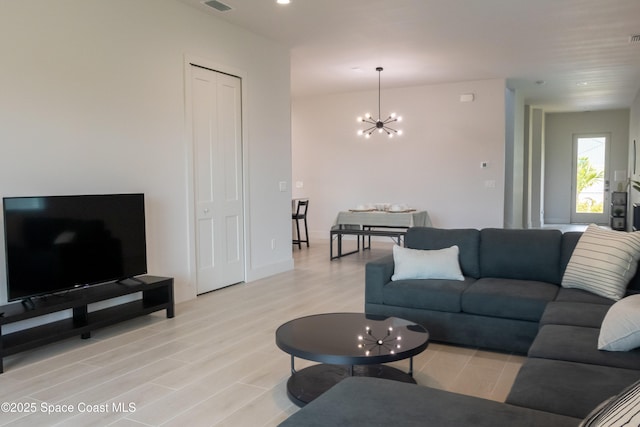 2148 Country Club Rd, Melbourne, FL 32901 - living room with light wood-style flooring and a chandelier
