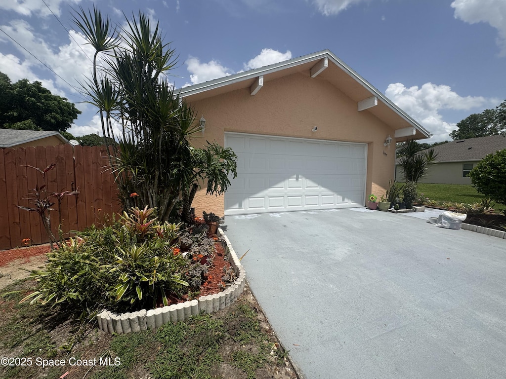1637 Kanabec Ave NW, Palm Bay, FL 32907 - view of front of property with driveway, stucco siding, and an attached garage