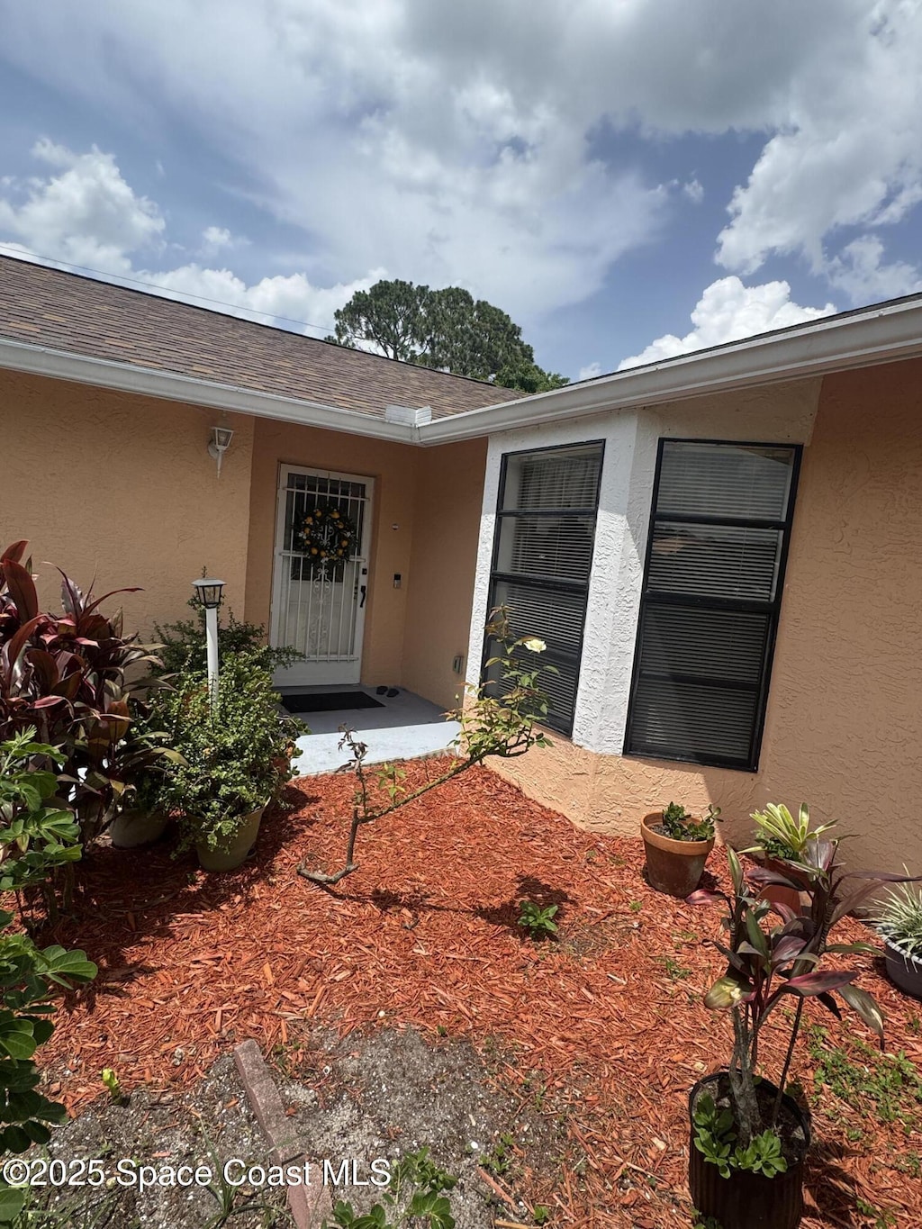 1637 Kanabec Ave NW, Palm Bay, FL 32907 - doorway to property with stucco siding