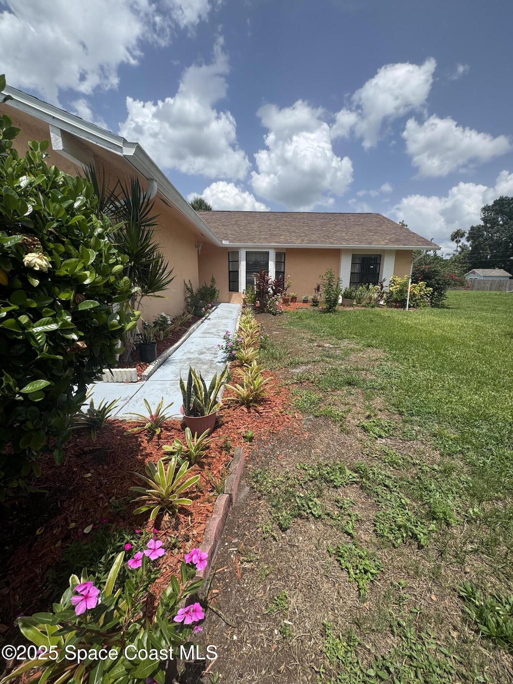 1637 Kanabec Ave NW, Palm Bay, FL 32907 - view of front of property featuring stucco siding and a front lawn