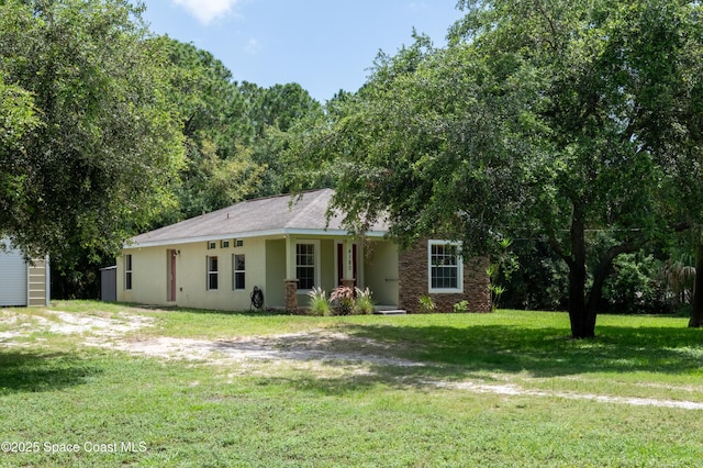 4180 Seville Ave, Cocoa, FL 32926 - ranch-style house featuring a front yard, covered porch, and stucco siding