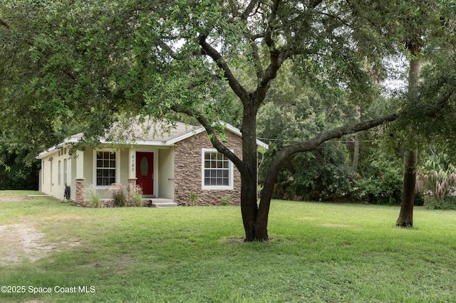 4180 Seville Ave, Cocoa, FL 32926 - view of front of property featuring stone siding and a front lawn