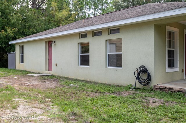 4180 Seville Ave, Cocoa, FL 32926 - back of property featuring stucco siding and a shingled roof