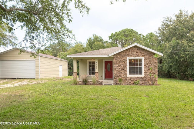 4180 Seville Ave, Cocoa, FL 32926 - view of front of home with stone siding, a front lawn, an outbuilding, and a garage