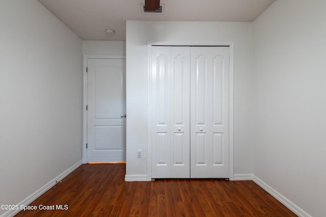 4180 Seville Ave, Cocoa, FL 32926 - unfurnished bedroom featuring dark wood-type flooring and a closet