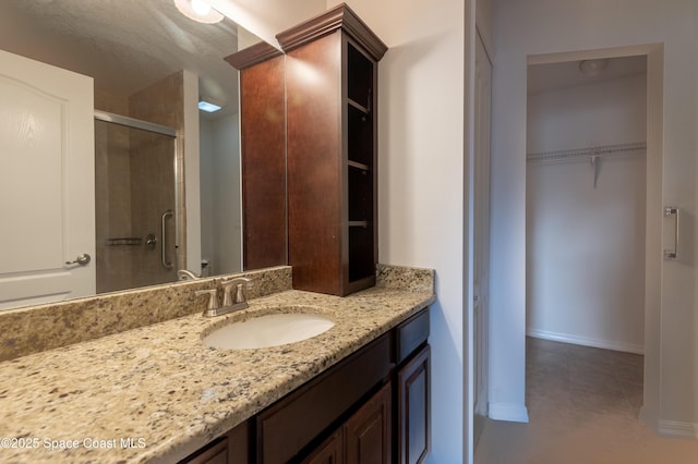 4180 Seville Ave, Cocoa, FL 32926 - full bathroom with a stall shower, vanity, a walk in closet, and tile patterned flooring