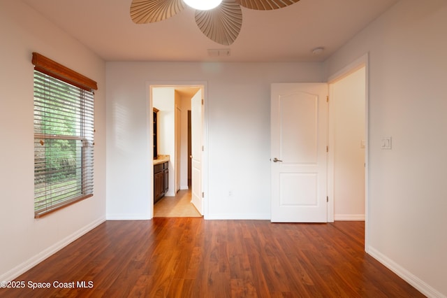 4180 Seville Ave, Cocoa, FL 32926 - unfurnished bedroom with wood finished floors, connected bathroom, and ceiling fan