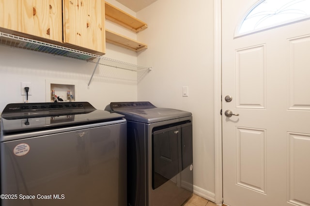 4180 Seville Ave, Cocoa, FL 32926 - laundry room with washer and dryer, cabinet space, and light tile patterned flooring