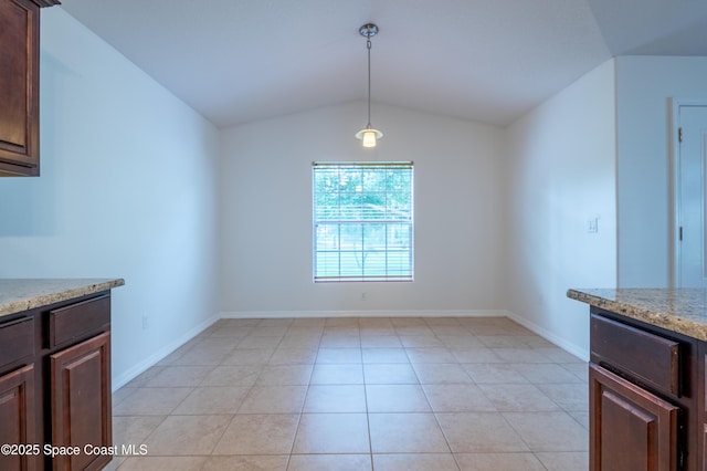 4180 Seville Ave, Cocoa, FL 32926 - unfurnished dining area with vaulted ceiling and light tile patterned flooring