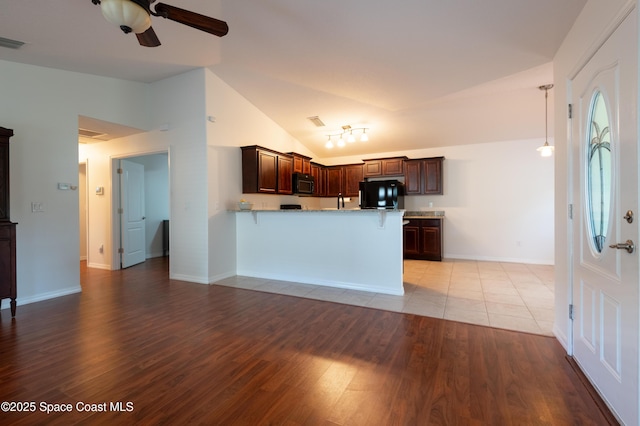 4180 Seville Ave, Cocoa, FL 32926 - kitchen featuring refrigerator, light wood-style flooring, a peninsula, a ceiling fan, and light countertops