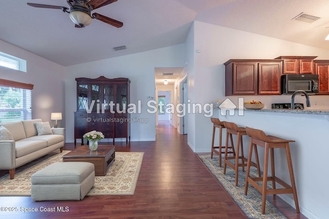 4180 Seville Ave, Cocoa, FL 32926 - living area with a ceiling fan, dark wood-type flooring, and high vaulted ceiling