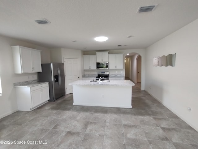 565 Sorrento Dr, Cocoa, FL 32922 - kitchen with appliances with stainless steel finishes, arched walkways, baseboards, and white cabinets