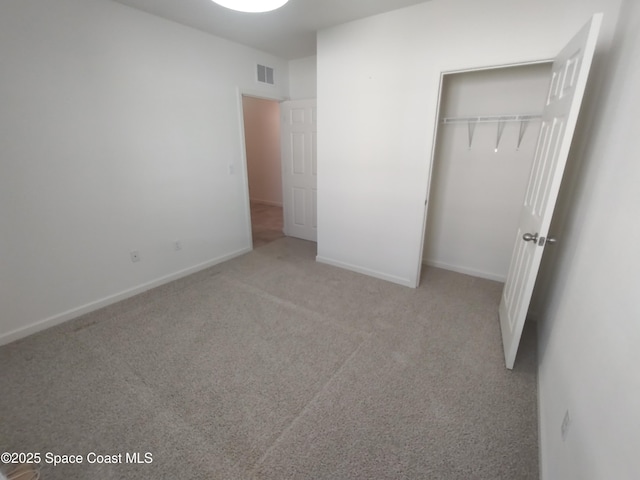 565 Sorrento Dr, Cocoa, FL 32922 - unfurnished bedroom with carpet flooring, a closet, and baseboards